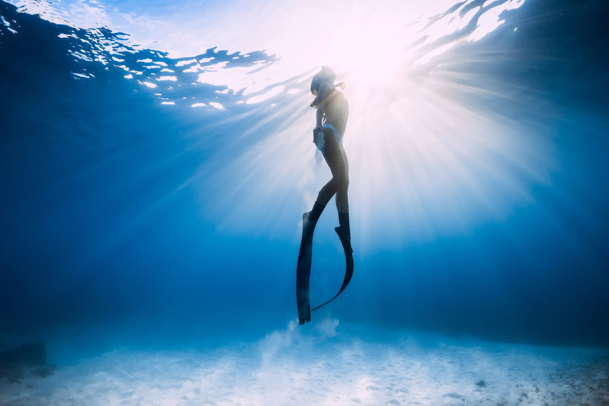 Freediver ascending in crystal clear Australian waters